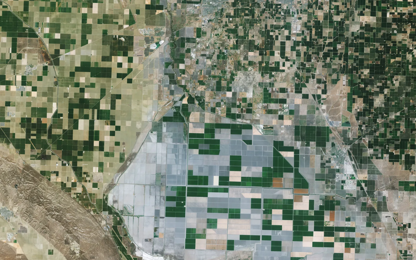 Satellite view of California's Central Valley agricultural landscape with dust and farmland